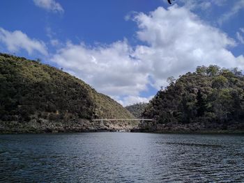Scenic view of river amidst trees against sky