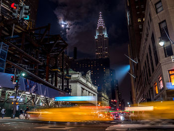 Illuminated city street and buildings at night