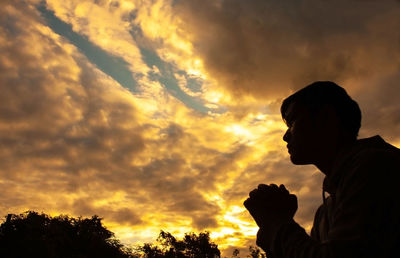 Low angle view of silhouette man against sky during sunset