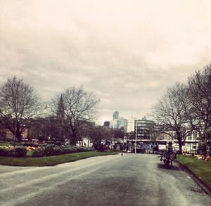 Empty road along buildings