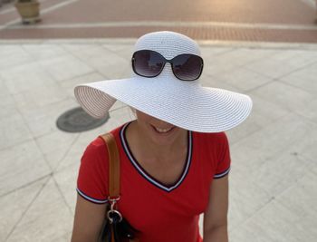 High angle view of cheerful woman wearing hat