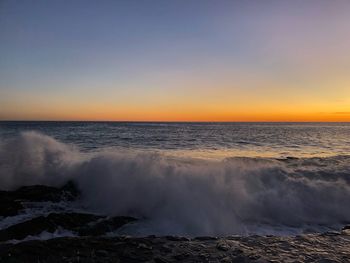 Scenic view of sea against clear sky during sunset