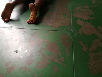 Low section of child on tiled floor