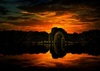 Scenic view of lake against romantic sky at sunset