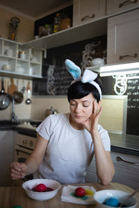 Portrait of young woman sitting on table