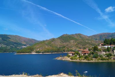 Calm lake against countryside landscape