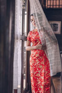 Woman standing by window