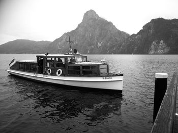 Ship in sea against mountains