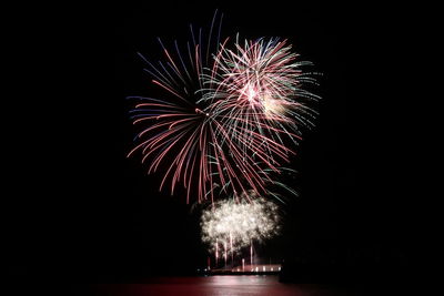 Low angle view of firework display at night