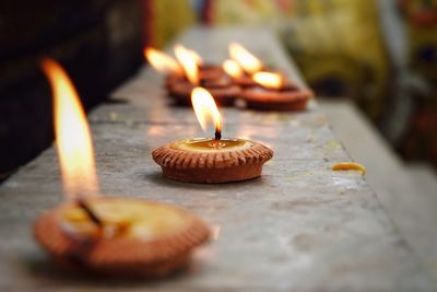 Close-up of diyas on steps