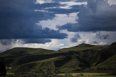 Scenic view of mountains against cloudy sky