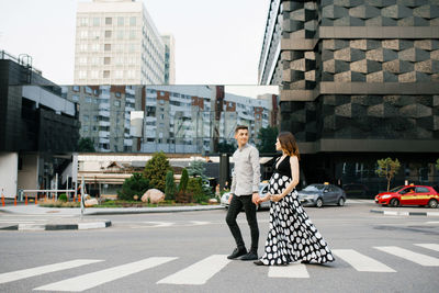 A young family is waiting for the baby. husband and wife look at each other as they walk through