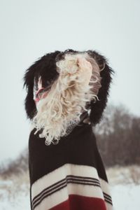 Woman in ethnic clothes shaking curly hair scenic photography