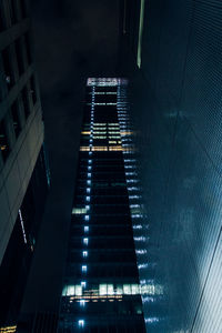 Low angle view of modern buildings in city at night