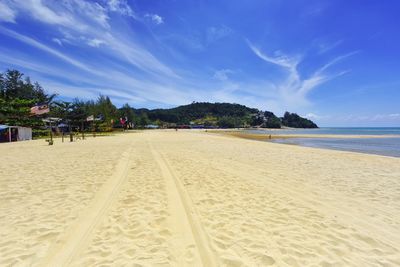 Scenic view of beach against blue sky