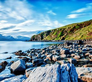 Scenic view of sea and mountains against sky