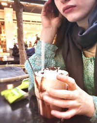 Midsection of woman holding drink