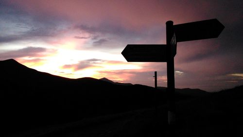 Low angle view of silhouette mountains against sky during sunset