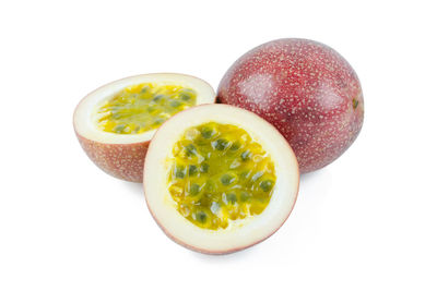 Close-up of fruits in bowl over white background