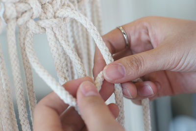 Close-up of hands holding rope