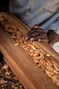 Close-up of man carving wood