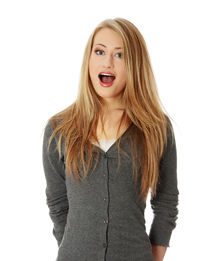 Portrait of young woman standing against white background