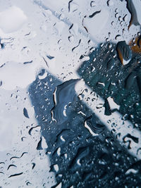 High angle view of raindrops on glass window