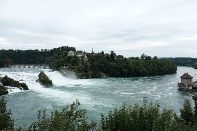 Scenic view of waterfall against sky