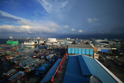 High angle view of harbor by sea against sky