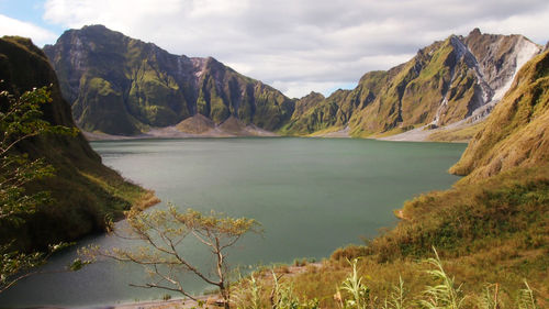 Scenic view of lake and mountains against sky