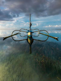 Calm view of karang beach with a traditional wooden fishing boat, at sanur, bali, indonesia.