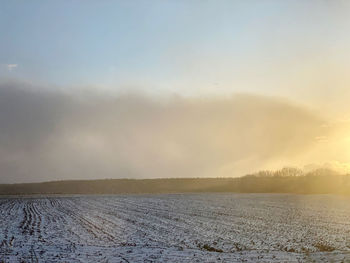 Scenic view of snow covered landscape against sky