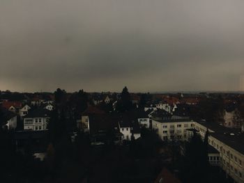 Cityscape against cloudy sky