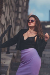 Young woman wearing sunglasses standing outdoors