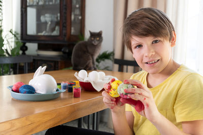 Cute little boy  painting easter eggs with paint brushes. diy, handmade. paints eggs for easter 