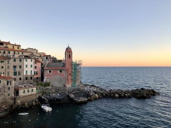 Scenic view of sea by buildings against clear sky, tellaro