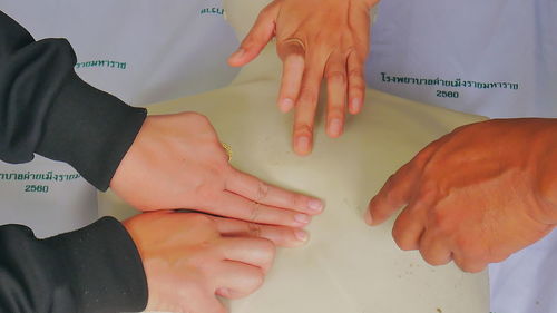 Cropped hands of paramedic practicing cpr on mannequin