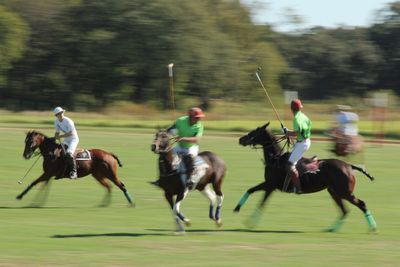 Two people riding horses