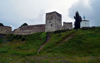 Low angle view of castle against cloudy sky