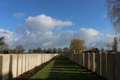 View of walkway against cloudy sky