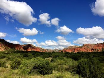 Scenic view of mountain range against cloudy sky