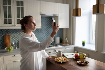 Woman having food at home