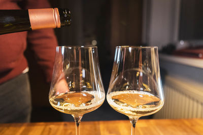 Close-up of  two wine glasses on table