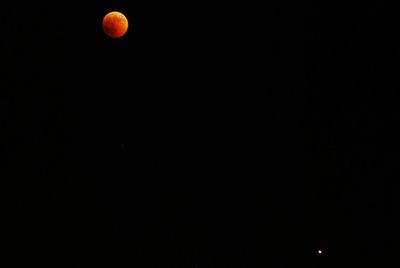 Low angle view of moon against sky at night