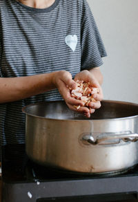 Midsection of man preparing food at home