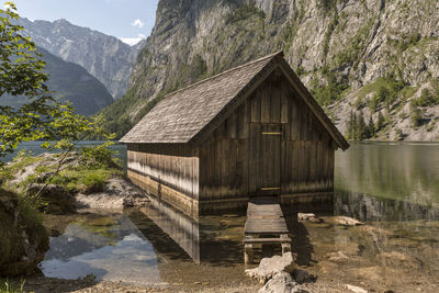 House by lake against mountain