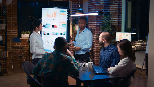 Group of people sitting on table