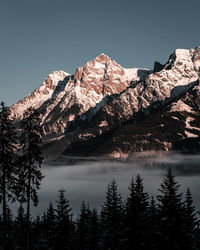 Scenic view of snowcapped mountains against clear sky