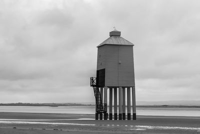 Lifeguard hut on beach against sky