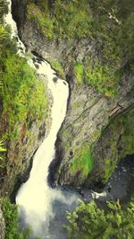 Scenic view of river flowing through rocks